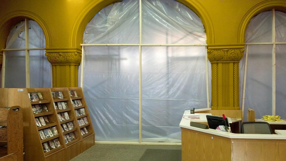 Why Use A Dust Containment System | Plastic covering an archway in a library